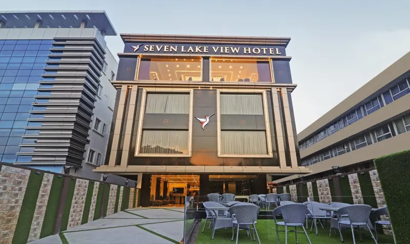 Seven Lake View Hotel building at dusk with rooftop terrace