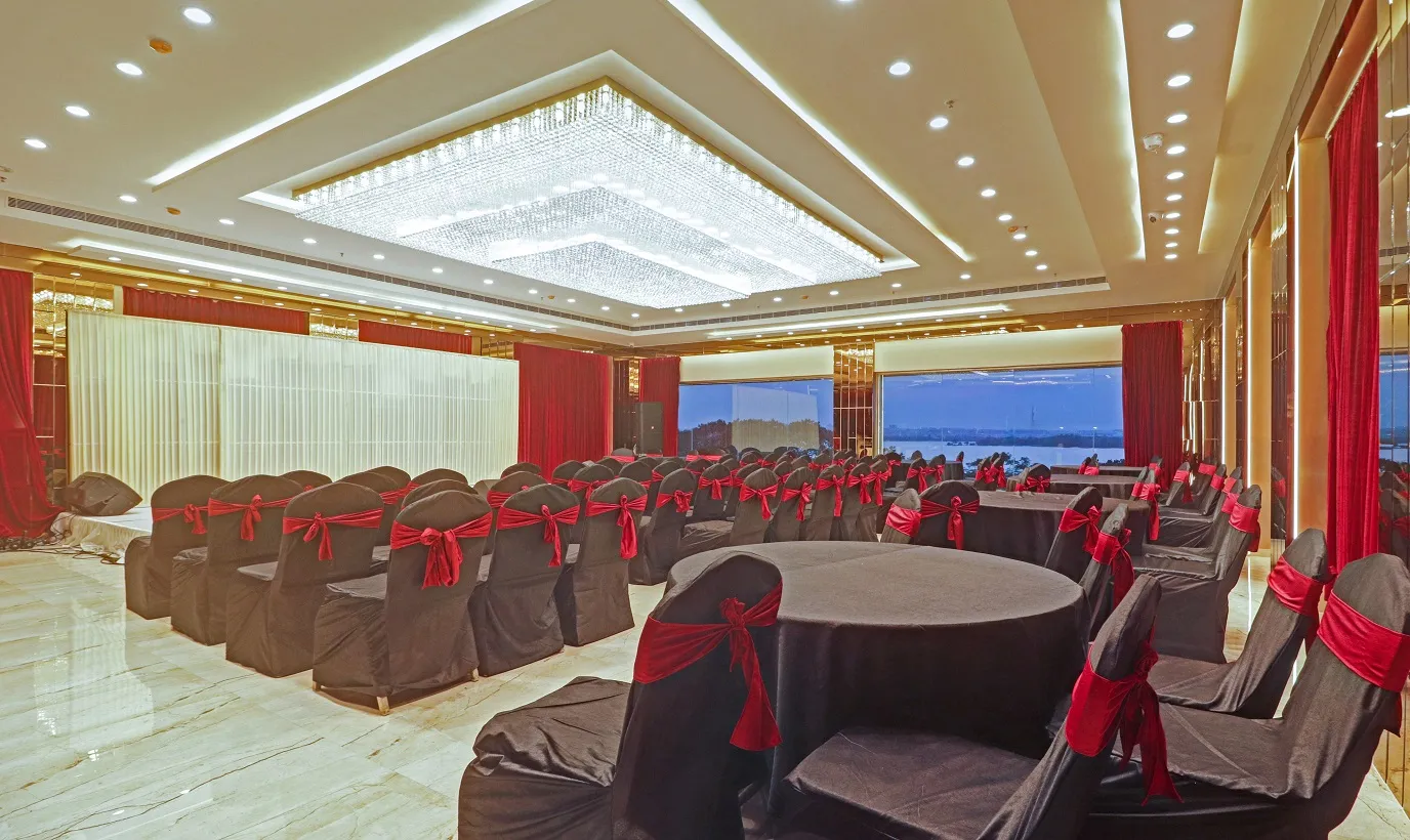 Banquet hall set with round tables and skyline views